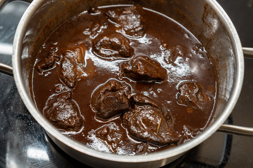 Geschmorte Hirschbacken in Sauce im Topf